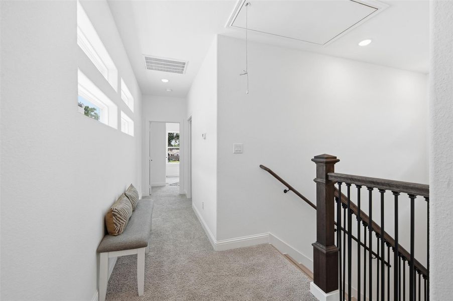 Upstairs hallway view from primary towards bedrooms 2 and 3