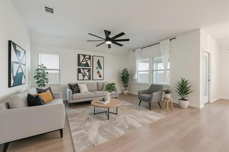 Living room featuring light wood-style floors and ceiling fan