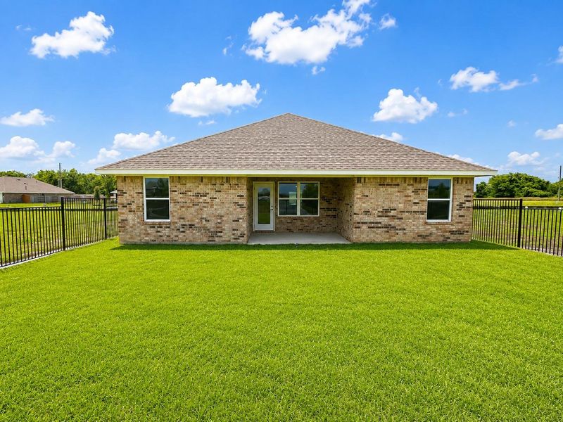 Peaceful backyard setting featuring open views, a covered patio area, and a well-maintained lawn perfect for enjoying the outdoors. Peaceful backyard setting featuring open views, a covered patio area, and a well-maintained lawn perfect for enjoying the outdoors.