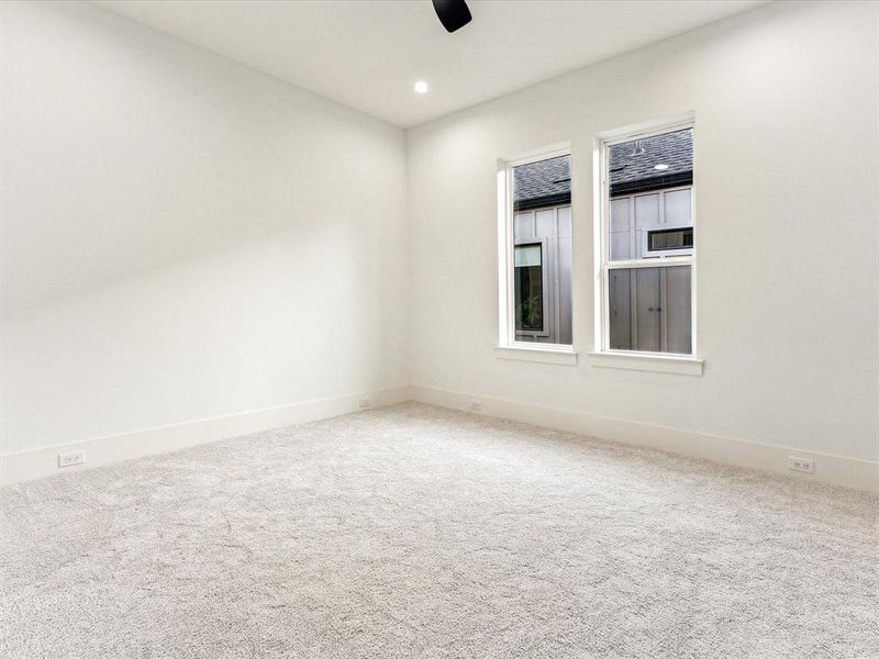 Empty room featuring ceiling fan and carpet