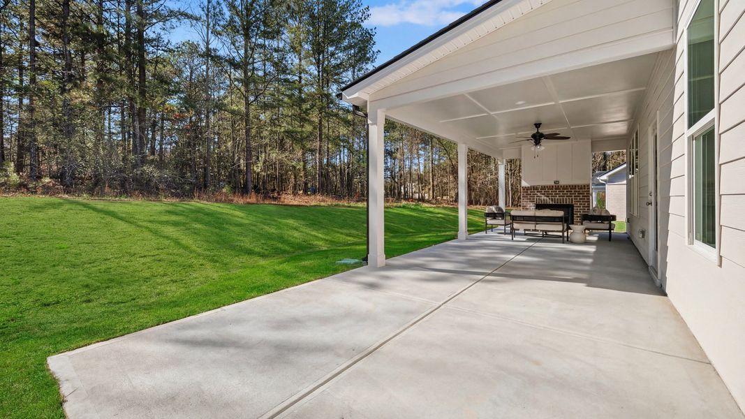 Spacious covered rear porch with fireplace Spacious covered rear porch with fireplace
