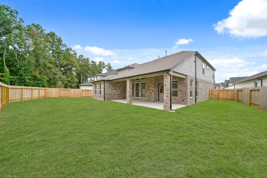 Front exterior of a new home in Barton Creek Ranch, Conroe, TX, highlighting curb appeal (Image 2). Front exterior of a new home in Barton Creek Ranch, Conroe, TX, highlighting curb appeal (Image 2).