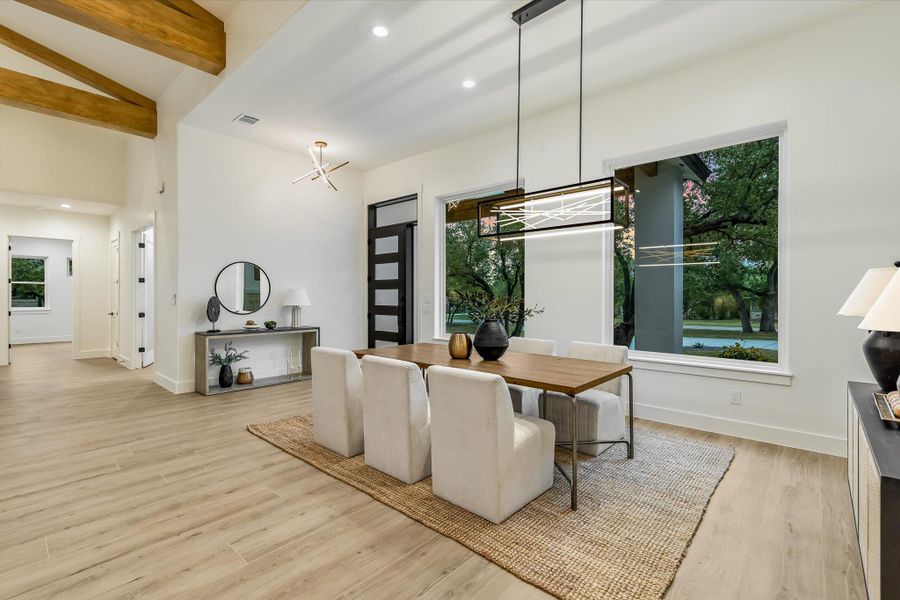 Dining room featuring recessed lighting, light wood finished floors, and vaulted ceiling with beams