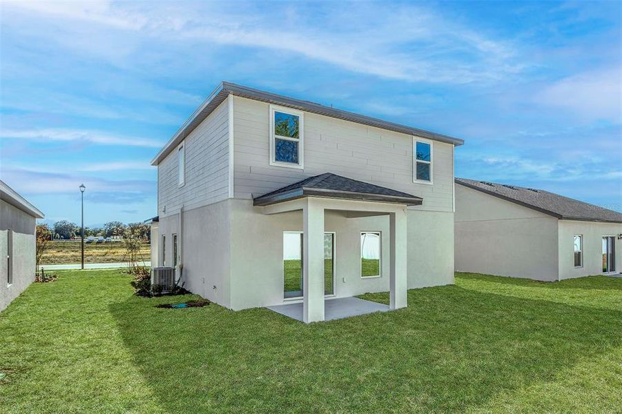 Front exterior of a new home in Tula Parc, Astatula, FL, highlighting curb appeal (Image 17).