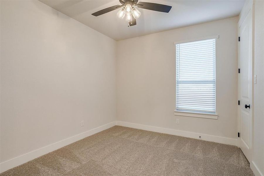 Empty room with carpet flooring and ceiling fan