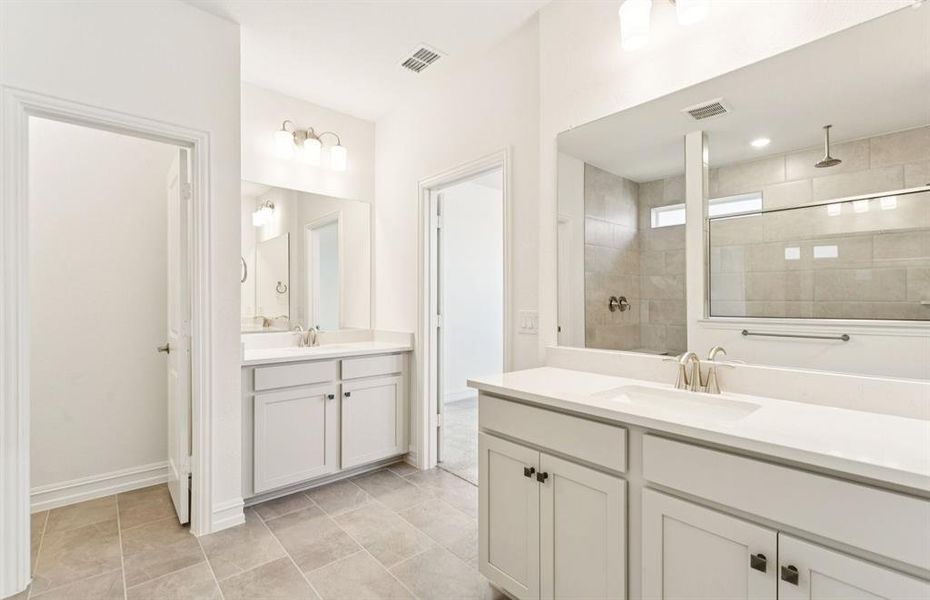 Spacious owner's bath with separate vanities