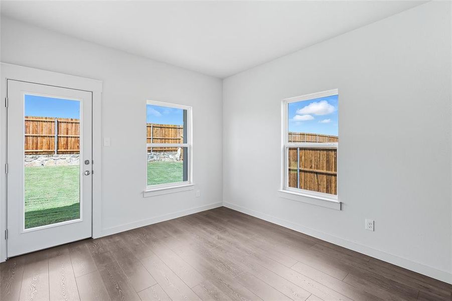 Spare room featuring wood finished floors and baseboards Spare room featuring wood finished floors and baseboards