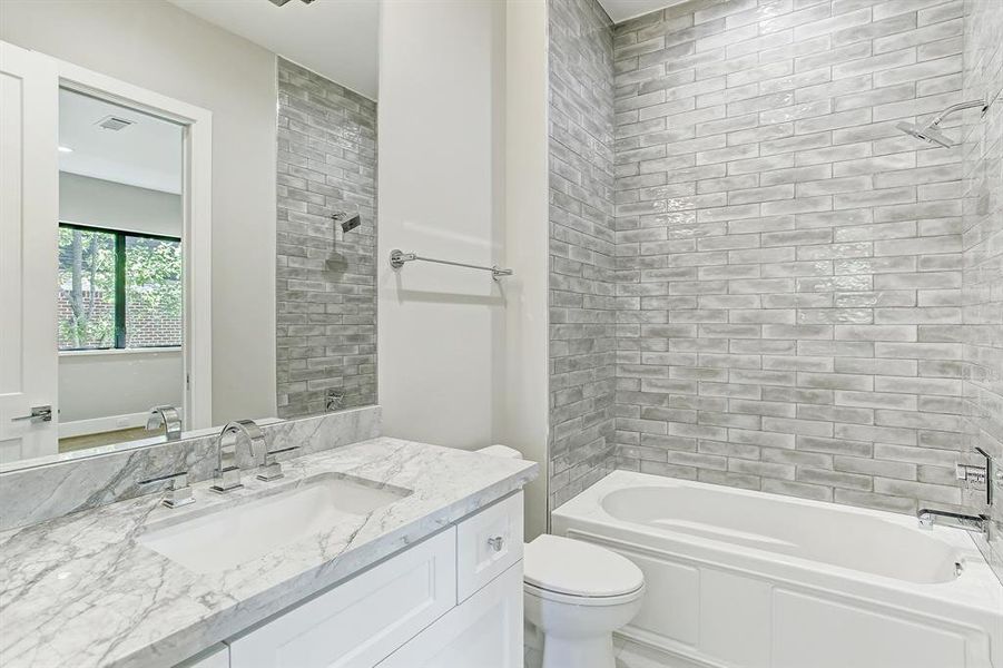 Each full bathroom with either walk-in shower or tub.  Please note lovely tile work which goes to the ceiling.