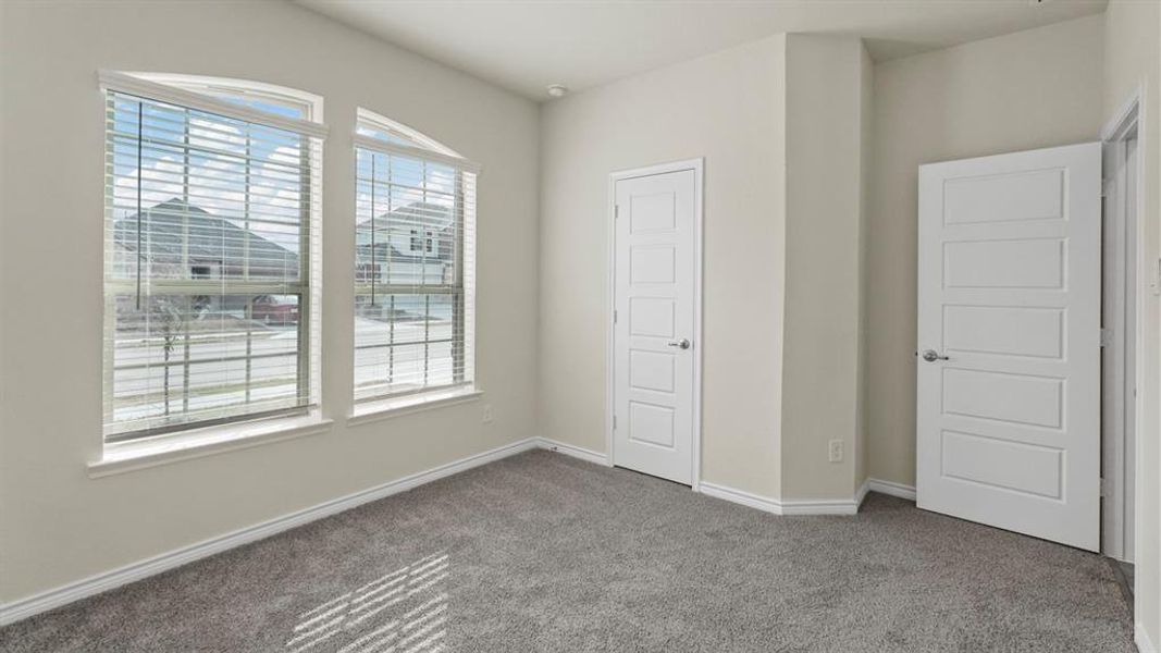 Unfurnished bedroom with carpet floors and baseboards Unfurnished bedroom with carpet floors and baseboards