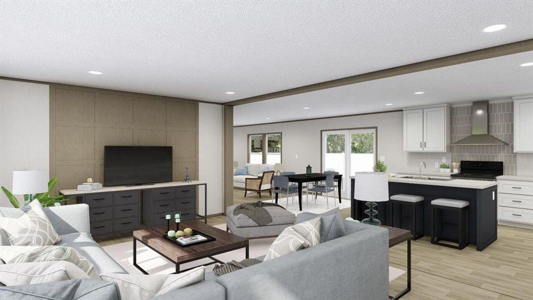 Living room featuring sink, light hardwood / wood-style flooring, and a textured ceiling