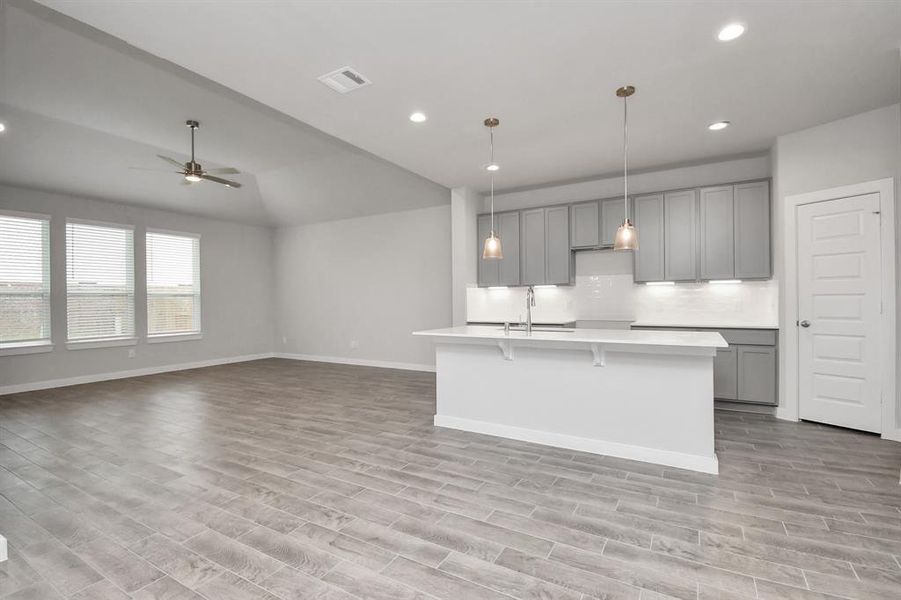 All of this overlooks your expansive family room, creating a perfect space for culinary delights and family gatherings. Sample photo of completed home with similar floor plan. Actual colors and selections may vary.