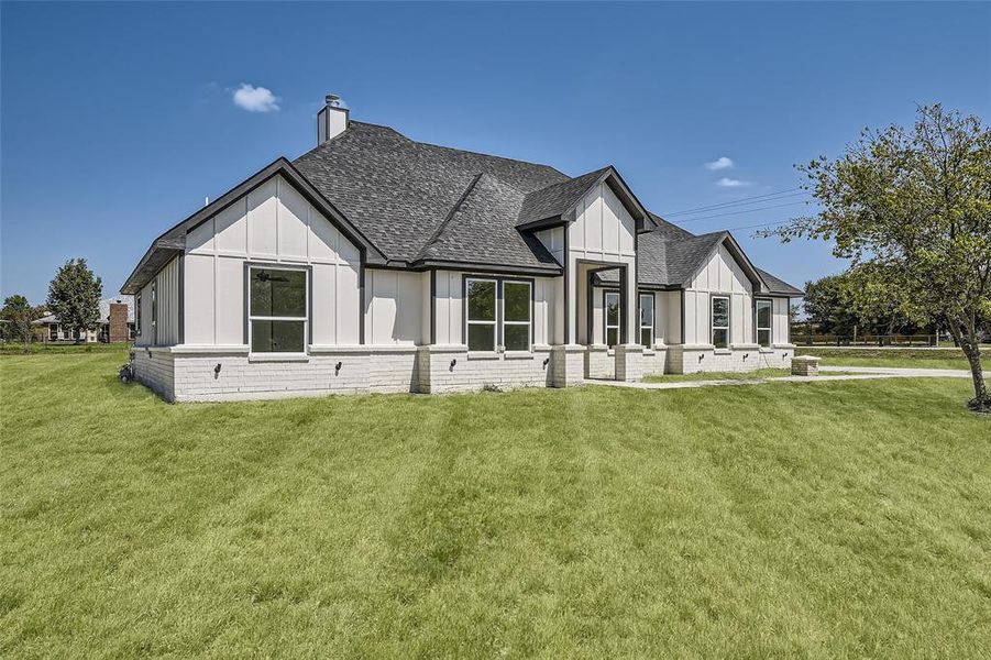 Modern inspired farmhouse with a front lawn