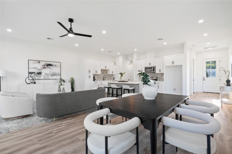 The home offers a seamless flow connecting all living spaces, creating an open and cohesive layout. Movement between the kitchen, dining, and living areas feels natural and effortless. This design enhances both functionality and the sense of spaciousness throughout the home.