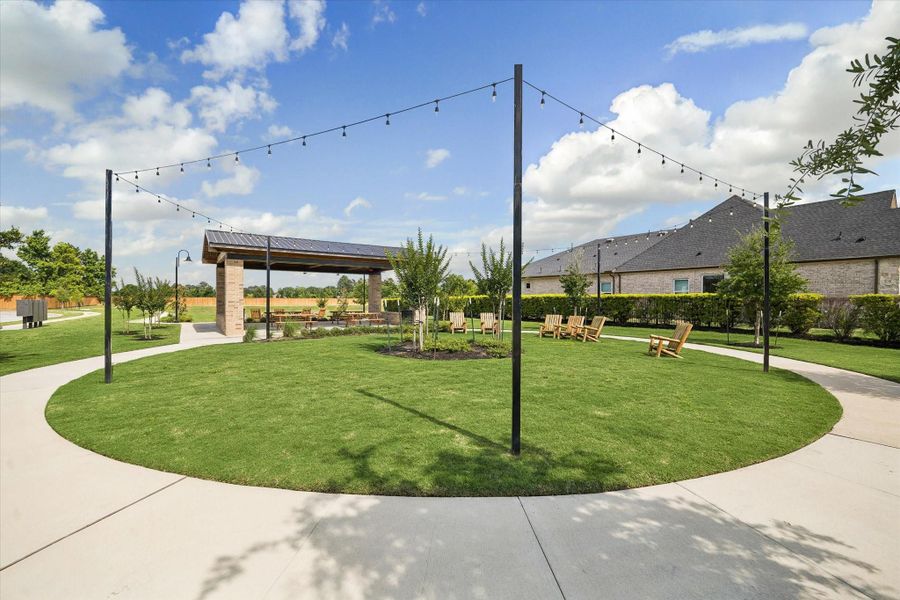 Residents enjoy this thoughtfully designed outdoor pavilion and community event lawn complete with charming café lighting, shaded seating, and open green space ideal for gatherings and outdoor enjoyment. Residents enjoy this thoughtfully designed outdoor pavilion and community event lawn complete with charming café lighting, shaded seating, and open green space ideal for gatherings and outdoor enjoyment.