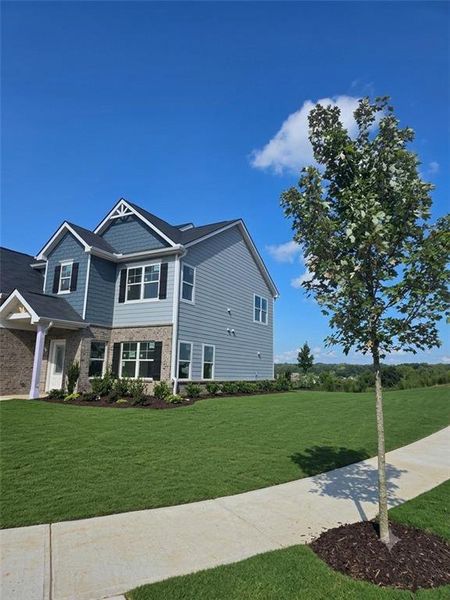 Front exterior of a new home in The Hills at Cedar Creek, Winder, GA, highlighting curb appeal (Image 2). Front exterior of a new home in The Hills at Cedar Creek, Winder, GA, highlighting curb appeal (Image 2).