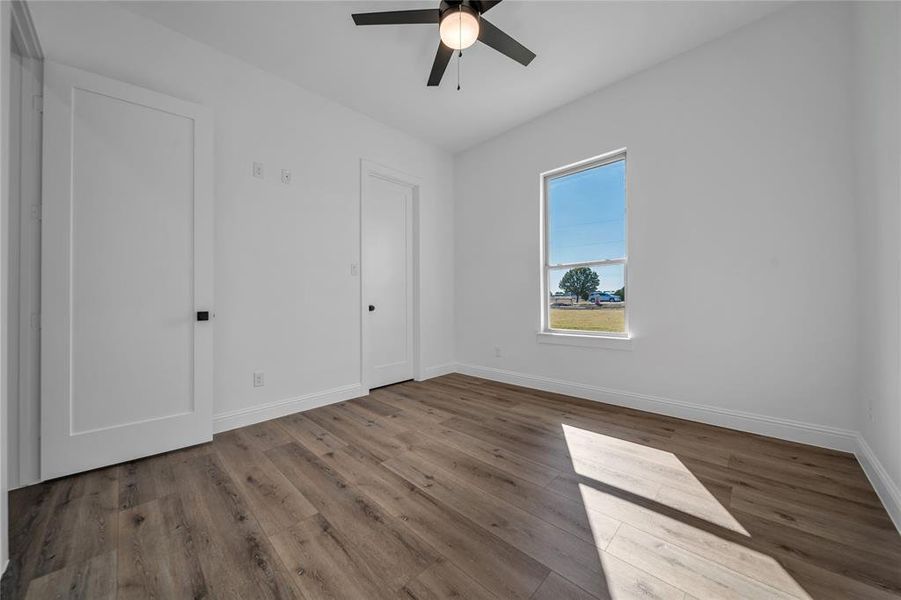 Unfurnished bedroom with a ceiling fan and wood finished floors