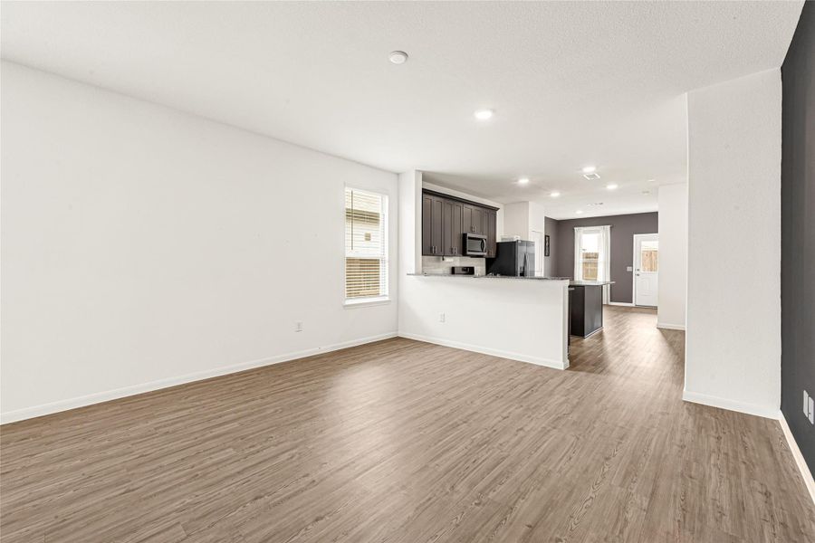 Bright, open-concept view from the living area looking directly into the kitchen and dining space.