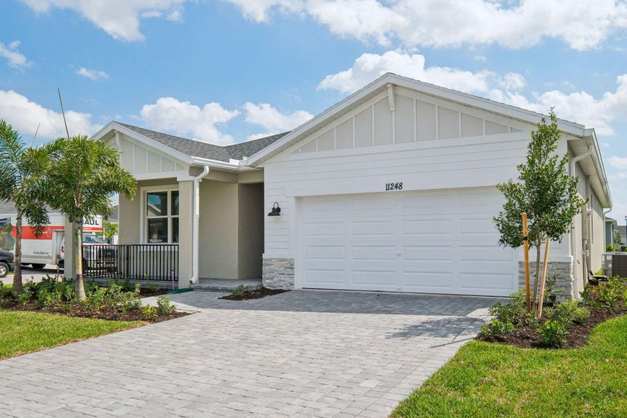 Front exterior of a new home in Brystol at Wylder - Reserve Series, Port St. Lucie, FL, highlighting curb appeal (Image 19). Front exterior of a new home in Brystol at Wylder - Reserve Series, Port St. Lucie, FL, highlighting curb appeal (Image 19).