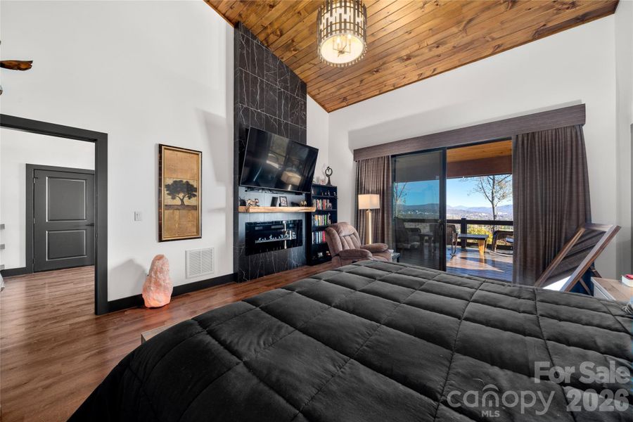 Primary retreat with the warmth of a beautiful floor to ceiling fireplace.