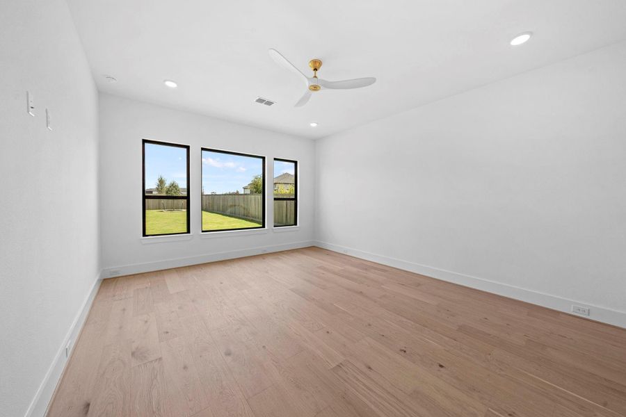 Spacious primary bedroom offering a comfortable layout, natural light, and contemporary finishes.
