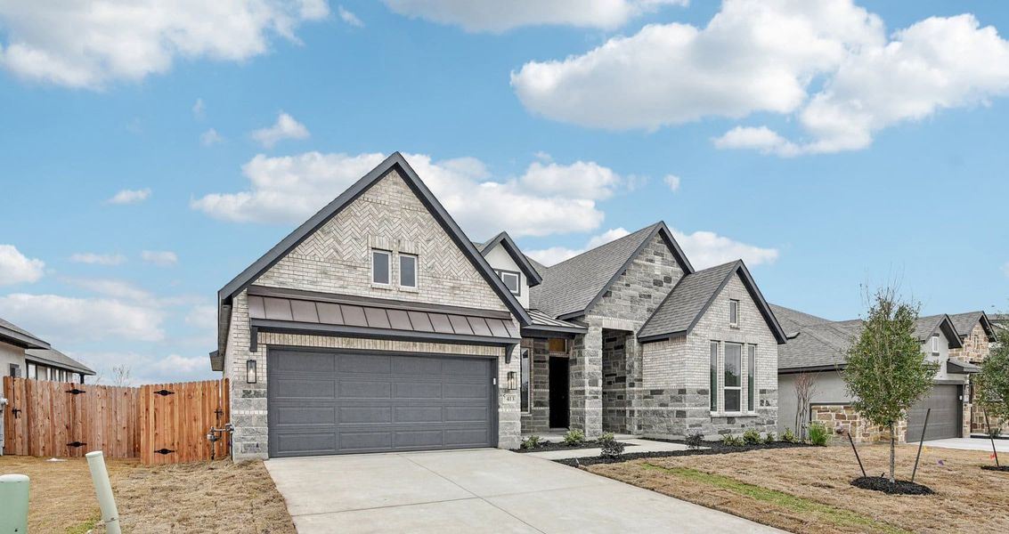 Front exterior of a new home in Village at Three Oaks, Seguin, TX, highlighting curb appeal (Image 2). Front exterior of a new home in Village at Three Oaks, Seguin, TX, highlighting curb appeal (Image 2).