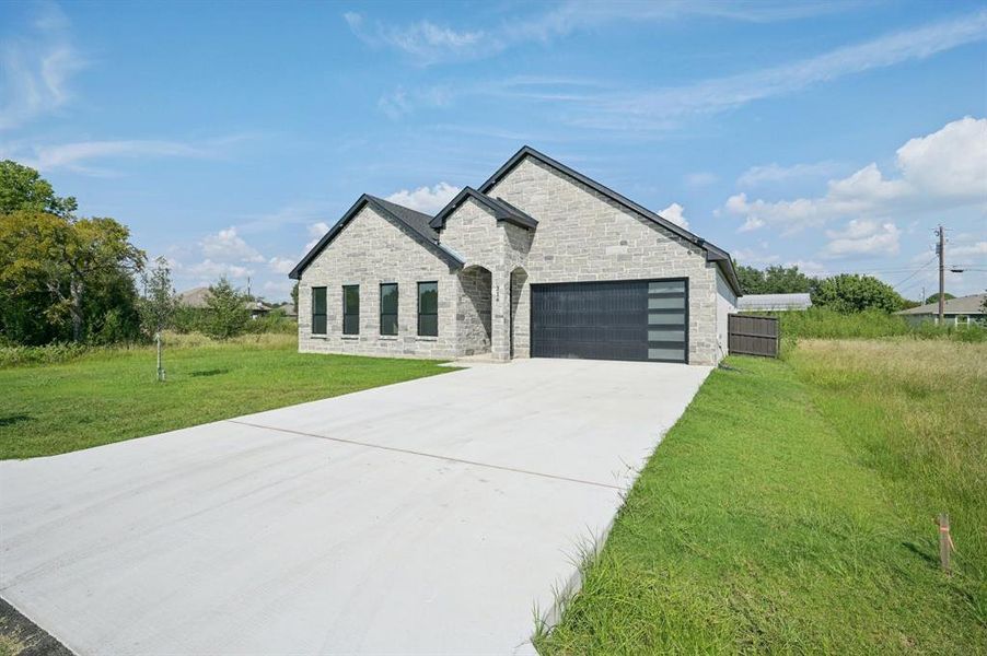 Front exterior of a new home in , Gun Barrel City, TX, highlighting curb appeal (Image 21). Front exterior of a new home in , Gun Barrel City, TX, highlighting curb appeal (Image 21).