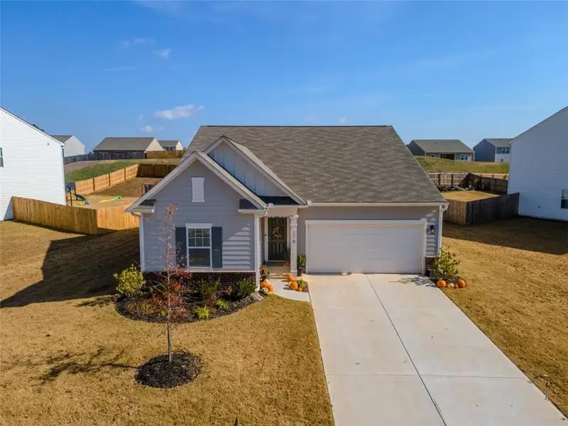 Front exterior of a new home in Bentwater, Hoschton, GA, highlighting curb appeal (Image 1). Front exterior of a new home in Bentwater, Hoschton, GA, highlighting curb appeal (Image 1).
