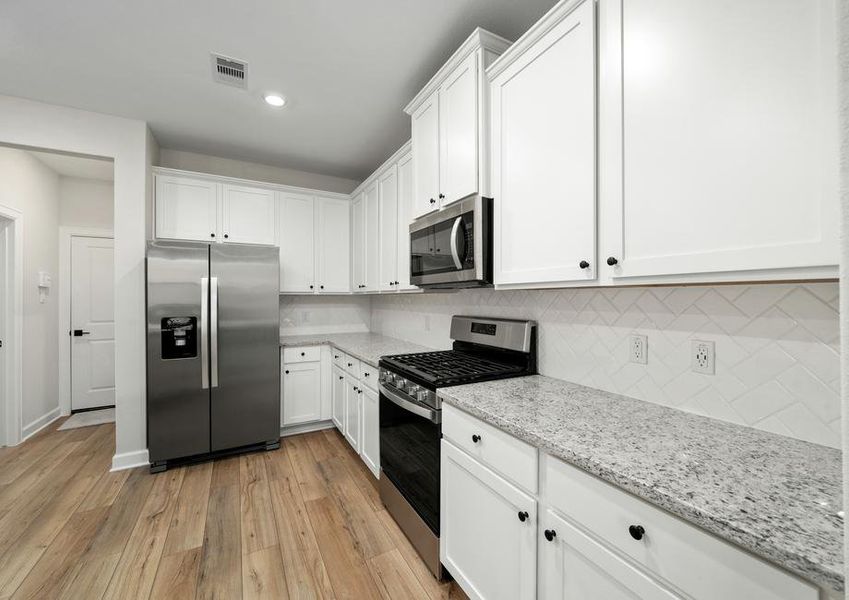 The kitchen has beautiful backsplash.