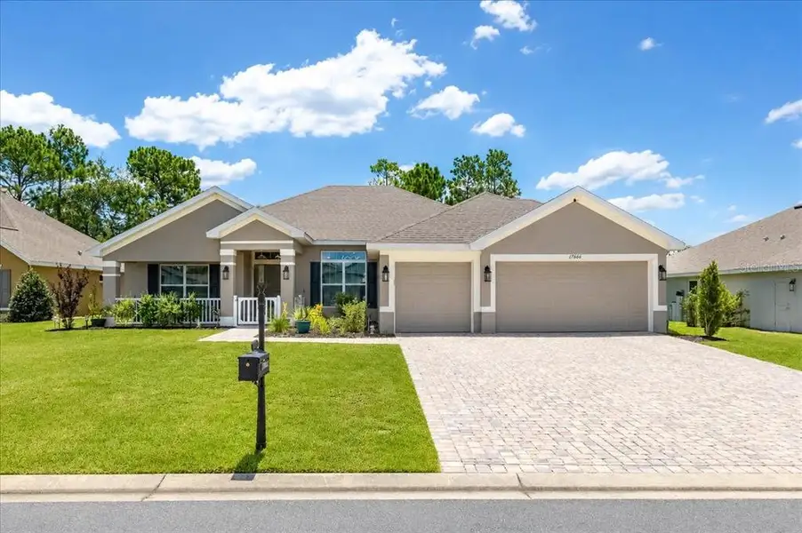 Front exterior of a new home in Juliette Falls, Dunnellon, FL, highlighting curb appeal (Image 27). Front exterior of a new home in Juliette Falls, Dunnellon, FL, highlighting curb appeal (Image 27).