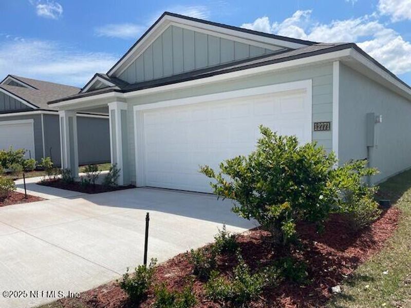 Front exterior of a new home in The Arbors, Jacksonville, FL, highlighting curb appeal (Image 20).