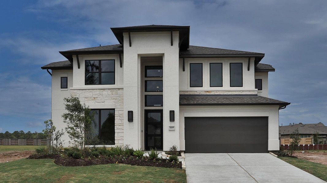 Front exterior of a new home in Artavia 55' - Valencia, Conroe, TX, highlighting curb appeal (Image 14). Front exterior of a new home in Artavia 55' - Valencia, Conroe, TX, highlighting curb appeal (Image 14).