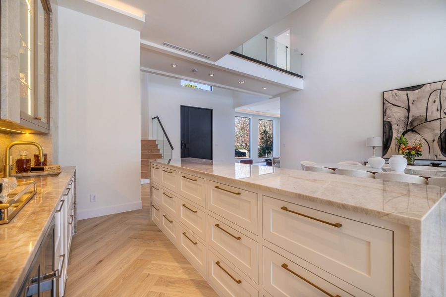 Secondary view of the custom wet bar showcasing cabinetry detail, beverage storage, and entertaining functionality. Secondary view of the custom wet bar showcasing cabinetry detail, beverage storage, and entertaining functionality.