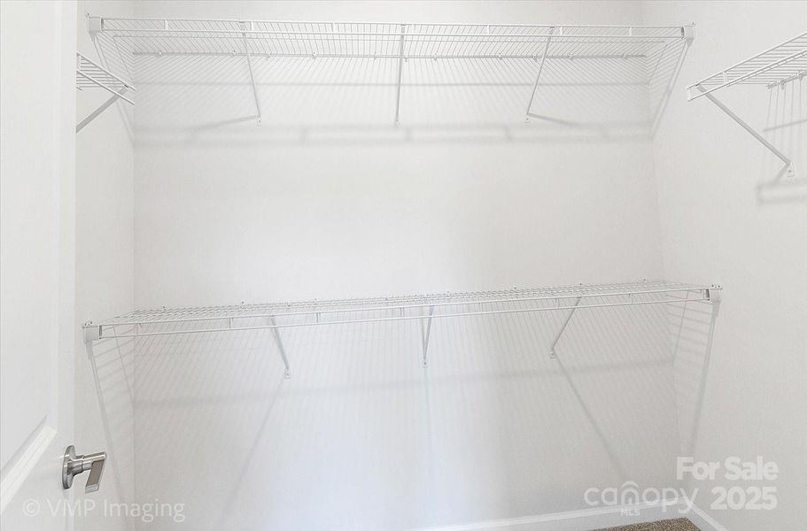 Primary walk-in closet Primary walk-in closet