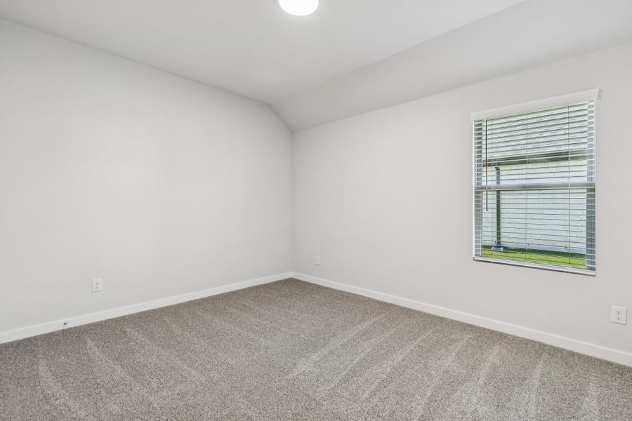 Bedroom in the Oscar home plan by Trophy Signature Homes – REPRESENTATIVE PHOTO