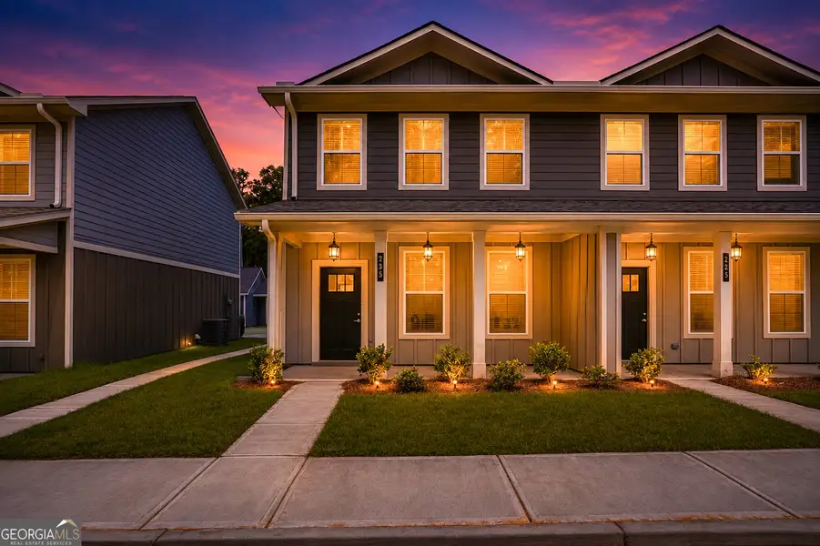 Front exterior of a new home in The Cottages at East Lanier, Fayetteville, GA, highlighting curb appeal (Image 1). Front exterior of a new home in The Cottages at East Lanier, Fayetteville, GA, highlighting curb appeal (Image 1).