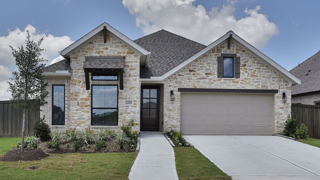 Front exterior of a new home in Riceland, Mont Belvieu, TX, highlighting curb appeal (Image 1). Front exterior of a new home in Riceland, Mont Belvieu, TX, highlighting curb appeal (Image 1).