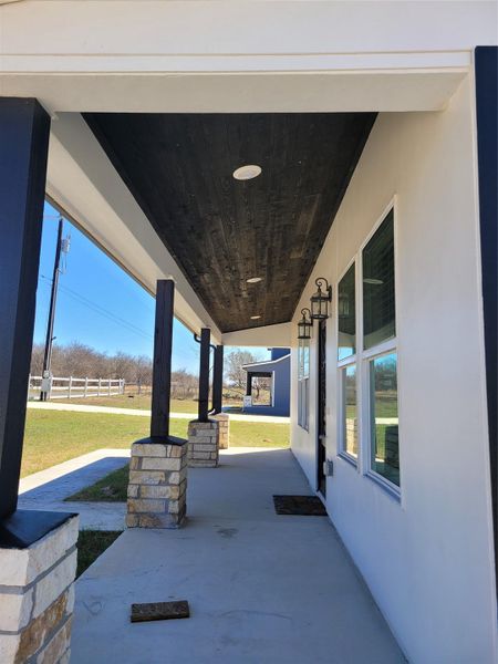 Covered porch with a lawn