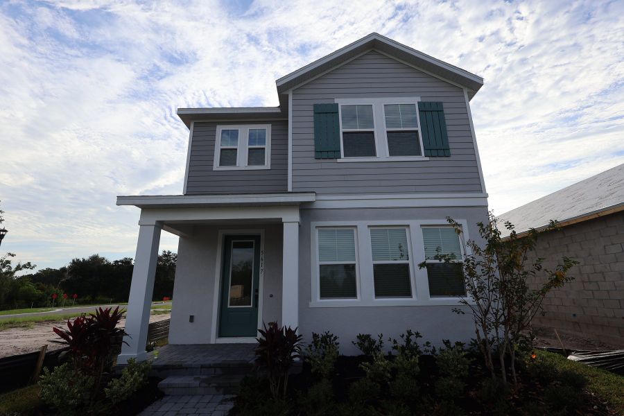 Front exterior of a new home in Palmeras at Crossprairie – The Magnolia Collection, St. Cloud, FL, highlighting curb appeal (Image 2). Front exterior of a new home in Palmeras at Crossprairie – The Magnolia Collection, St. Cloud, FL, highlighting curb appeal (Image 2).
