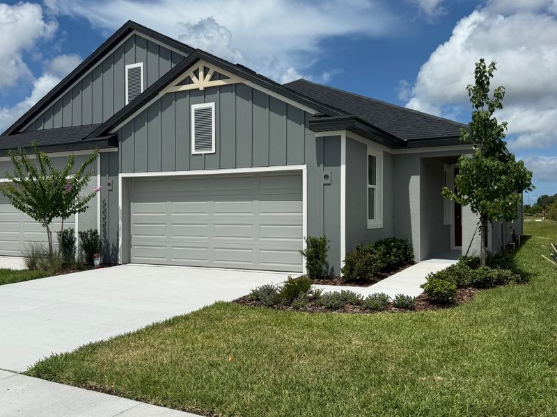 Front exterior of a new home in Fairway Pointe - Villa Community, Sun City Center, FL, highlighting curb appeal (Image 1). Front exterior of a new home in Fairway Pointe - Villa Community, Sun City Center, FL, highlighting curb appeal (Image 1).