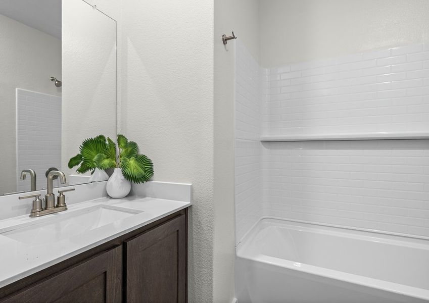 The secondary bathroom has a sprawling vanity.