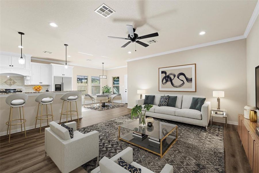 Living room featuring dark wood-type flooring, ceiling fan, ornamental molding, and recessed lighting. This picture has been virtually staged.