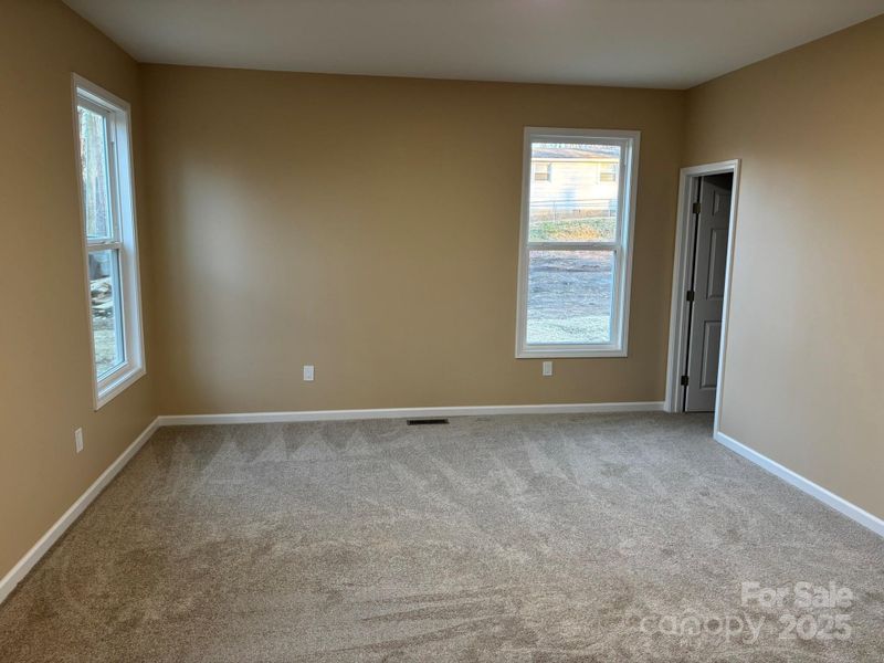 Large primary bedroom with 9 ft ceilings and plenty of natural sunlight. Large primary bedroom with 9 ft ceilings and plenty of natural sunlight.