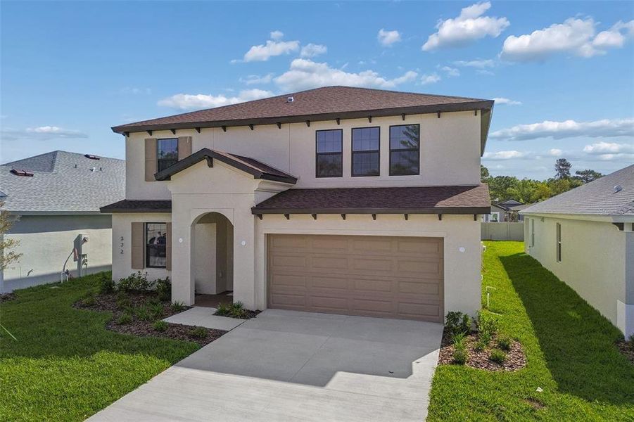 Front exterior of a new home in Avalon West, Spring Hill, FL, highlighting curb appeal (Image 33).