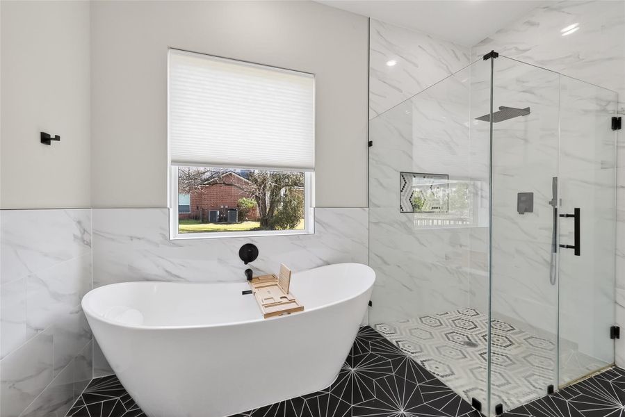 Bathroom view highlighting glass-enclosed shower and window. Bathroom view highlighting glass-enclosed shower and window.