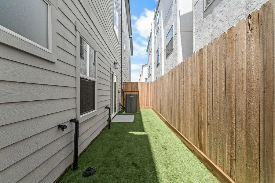 Just as the interior balances beauty and practicality, the outdoor spaces were planned with versatility in mind. The private fenced yard extends the home's livable footprint, offering a secure and low-maintenance setting that adapts easily to a variety of lifestyles.