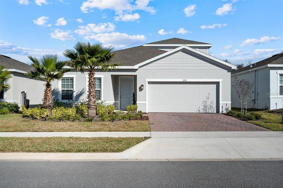 Front exterior of a new home in , Minneola, FL, highlighting curb appeal (Image 22).