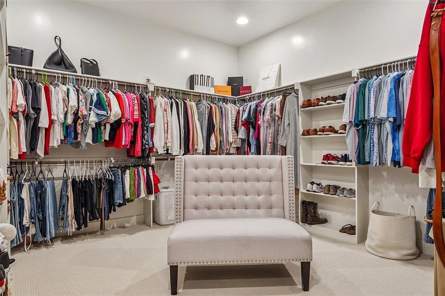 Massive primary bedroom walk in closet complete with seating area
