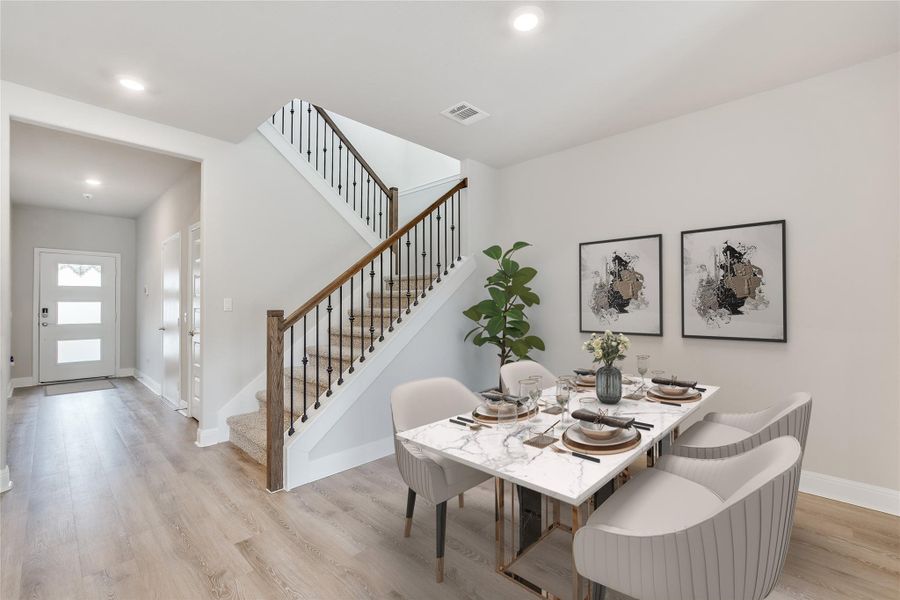 Dining space with light wood finished floors, recessed lighting, visible vents, baseboards, and stairs