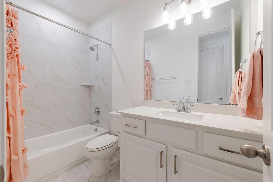 Bathroom with shower / tub combo and vanity