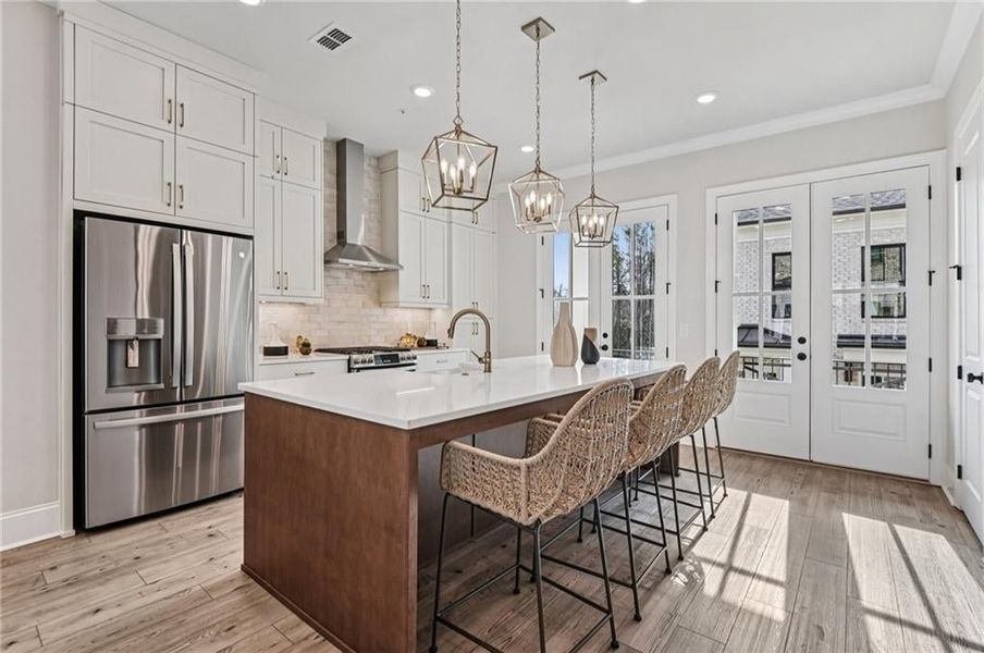 Tons of natural light with the dual balcony French doors- if you like to cook you will love this kitchen: beautiful design detail and upgraded appliance package:  GA Profile Series